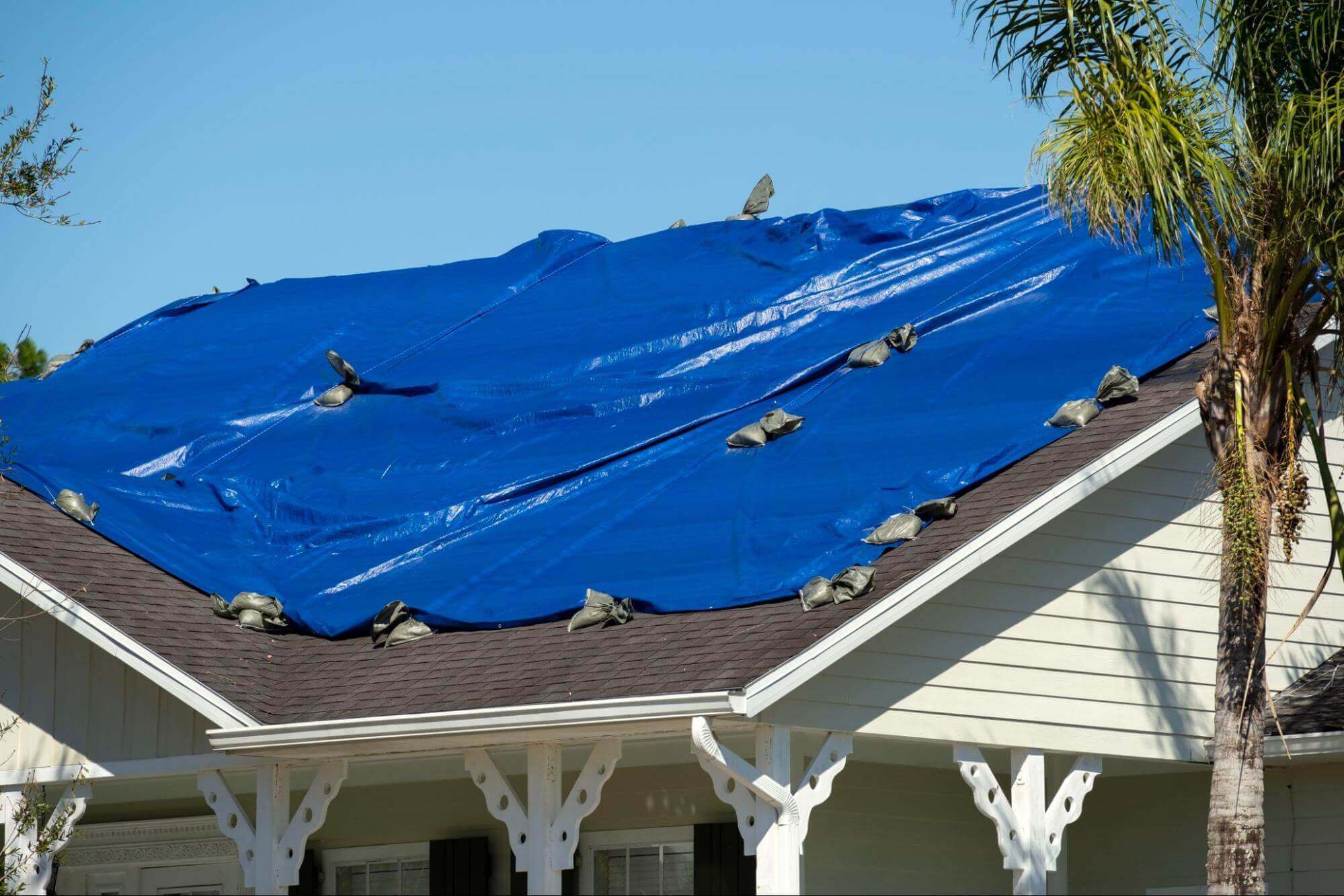 A leaking roof with a blue tarp.