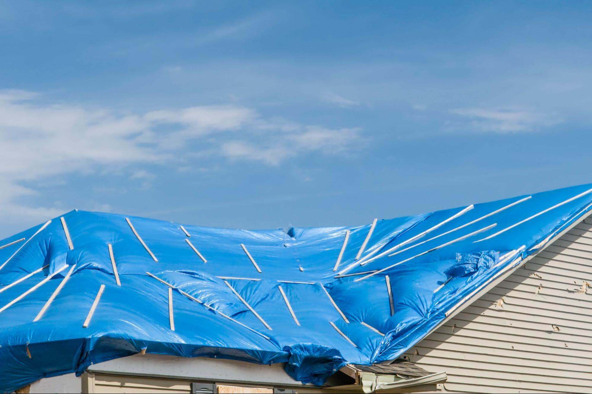 A tarp covering a damaged roof.