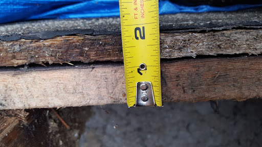 Measuring to repair a hole in a roof.