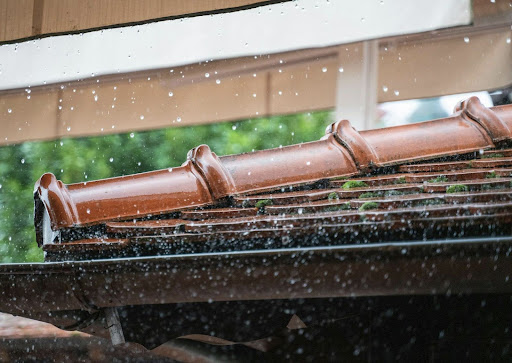 A tiled roof is rained on during a storm