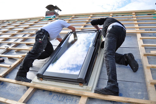 Roofers installing a new skylight