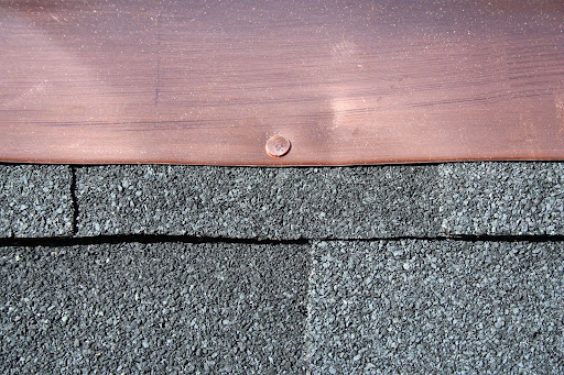 Roofing shingles and copper flashing.