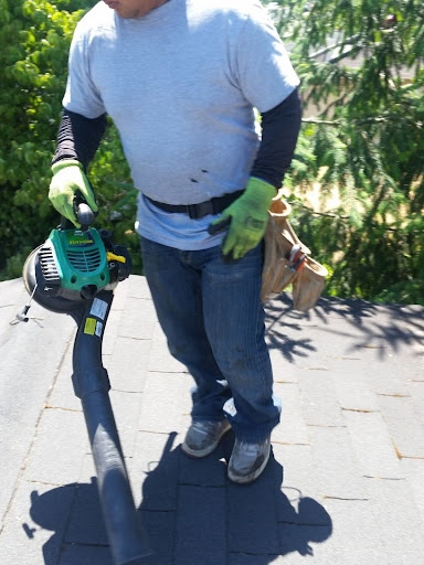 A roofer cleaning a roof.