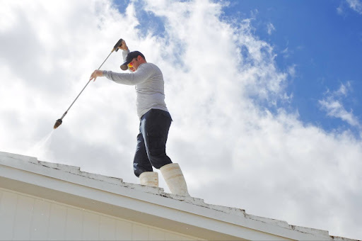 A roofer treats a roof.