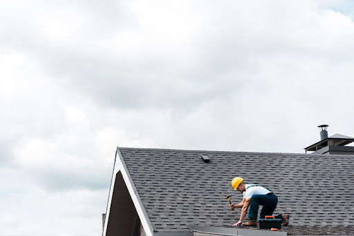 A roofer with a hammer