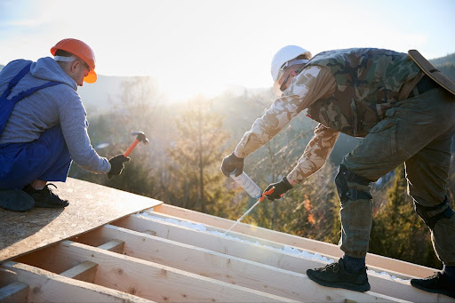 Two roofers working on a roof